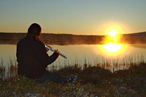 The flute player facing the midnight sun.