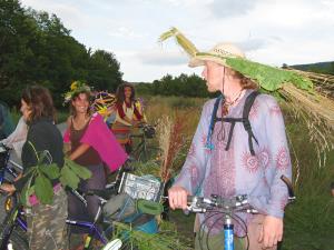 Some biketour cyclists dressed according to the theme flying just before arriving to Ecotopia