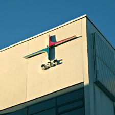 A corner of the CSC building with the company logo in morning light.