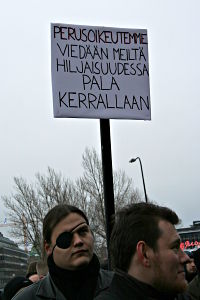A sign saying (translation): Our basic rights are being taken away from us in silence, piece by piece.