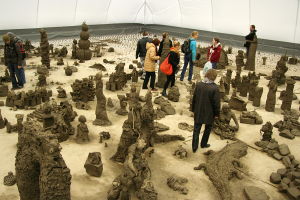 Clay works and people watching them. Picture taken from the center, on top of the remaining pile of clay.