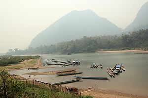 River boats on the Nam Ou river, in front of the Muang Ngoi village.