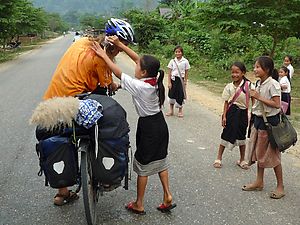 Schoolchildren wishing Arto Happy Lao New Year in the traditional way. Photo by Sandra Wilke.