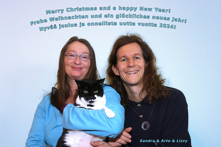 A portrait of us with our beloved cat Lizzy, December 2023.